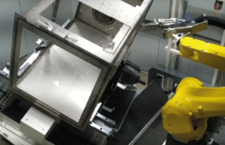 One of the gloveboxes being cut down by the laser cutting robot within the Laser Castle.
