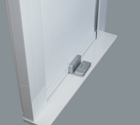 Close-up of Lasermet’s Dual Channel Interlock Switch beneath roller blind system